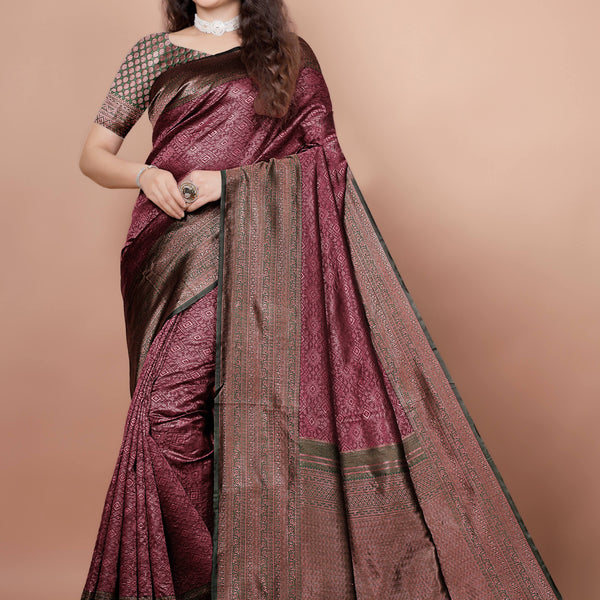 Woman modeling a beautiful maroon and green woven silk saree