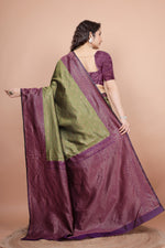 Back view highlighting the textured cherry blouse and the flowing woven pallu