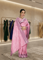 Model gracefully draped in a beautiful soft pink woven jacquard silk saree