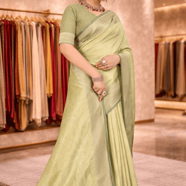 Elegant front half drape of a monotone pista green silk saree with matching blouse