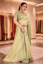 Elegant front half drape of a monotone pista green silk saree with matching blouse